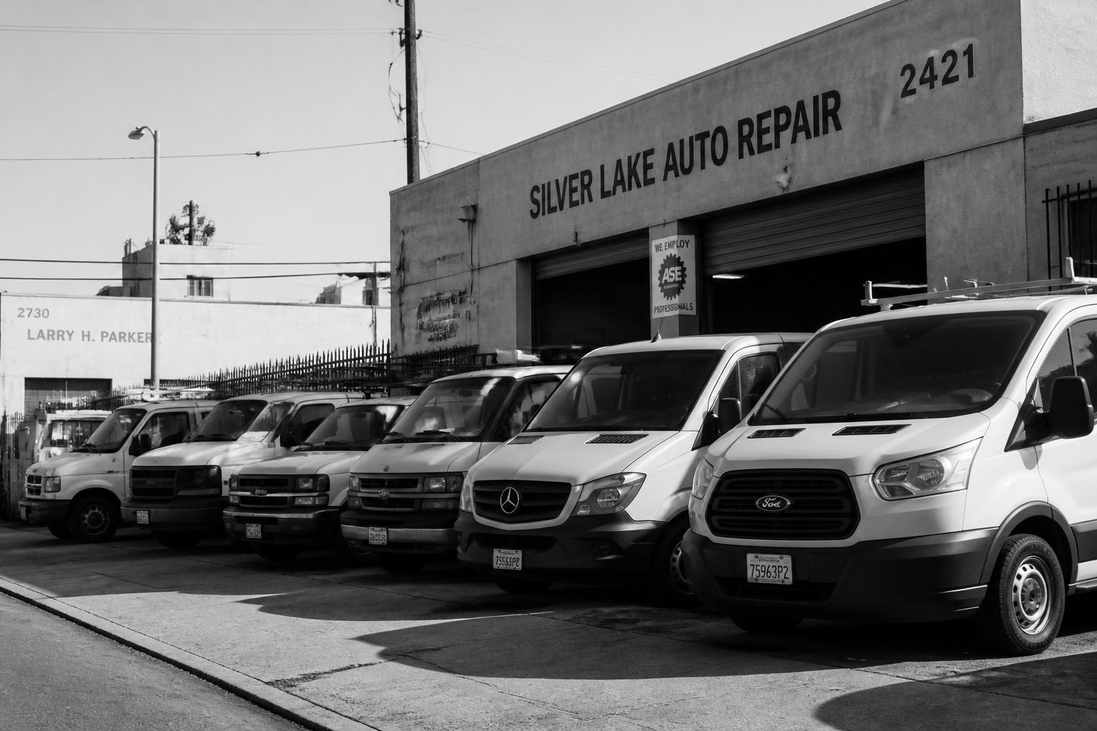 Fleet vans parked outside a Los Angeles auto repair shop